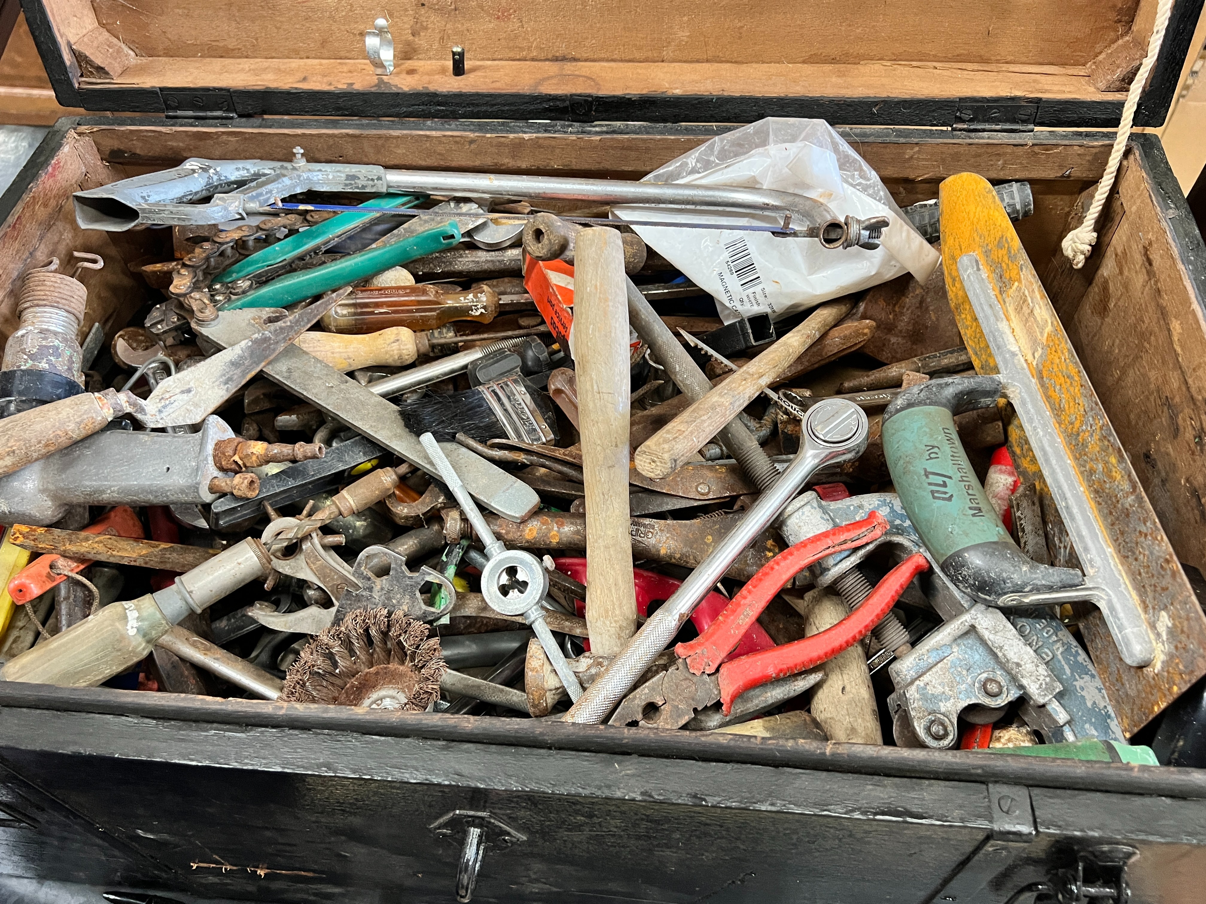 A painted iron bound chest containing a large quantity of assorted hand tools